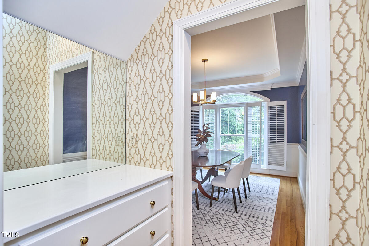 8605 Stanton Place Raleigh, NC 27615 - Photo 26 of 56 a view of a room that has a bed and a table in it
