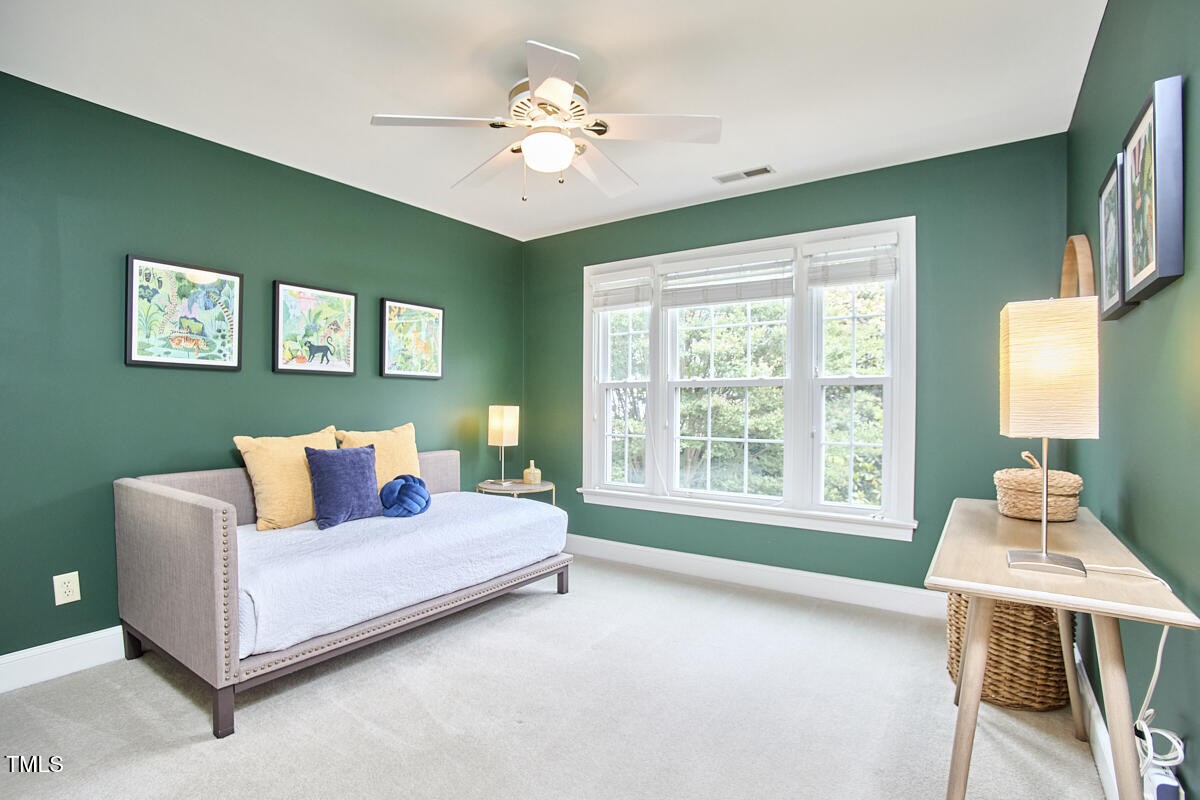 8605 Stanton Place Raleigh, NC 27615 - Photo 38 of 56 a bedroom with a bed and a chandelier