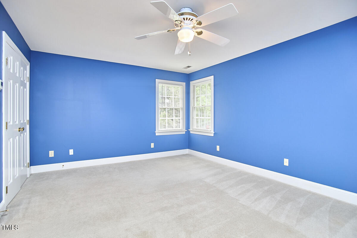 8605 Stanton Place Raleigh, NC 27615 - Photo 39 of 56 an empty room with windows and fan