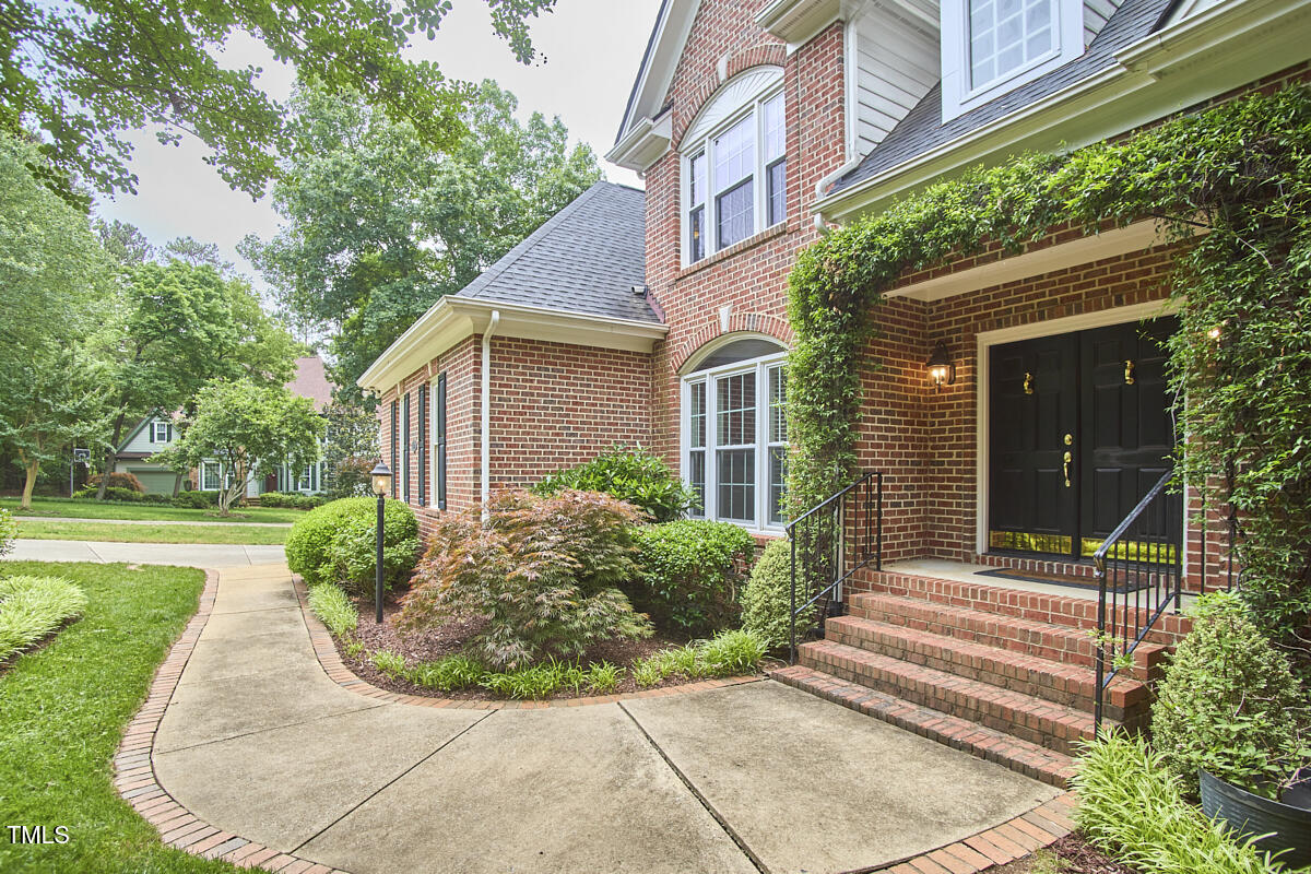 8605 Stanton Place Raleigh, NC 27615 - Photo 4 of 56 front view of a house with a yard
