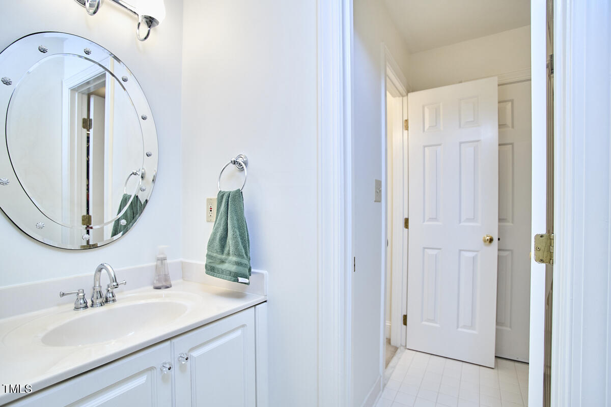 8605 Stanton Place Raleigh, NC 27615 - Photo 41 of 56 a bathroom with a sink vanity and a mirror