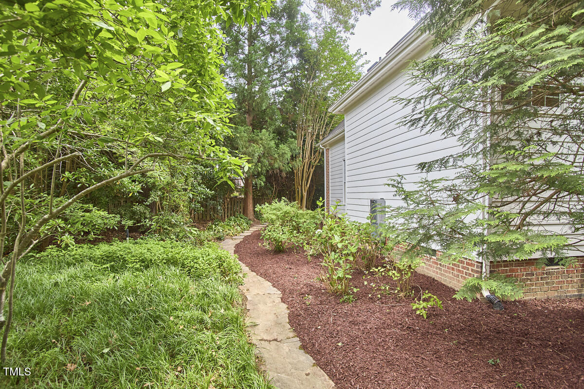 8605 Stanton Place Raleigh, NC 27615 - Photo 54 of 56 a view of a backyard with plants and large trees
