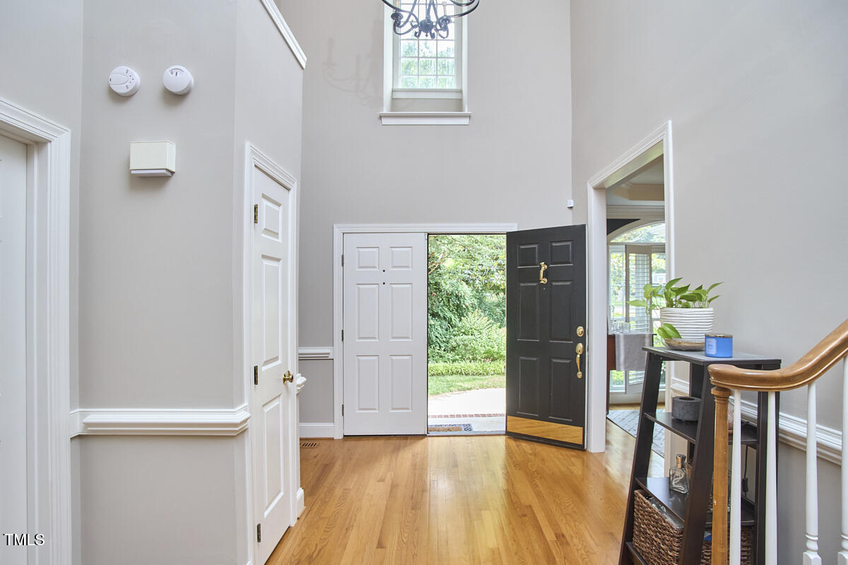 8605 Stanton Place Raleigh, NC 27615 - Photo 7 of 56 a view of a hallway with wooden floor and staircase