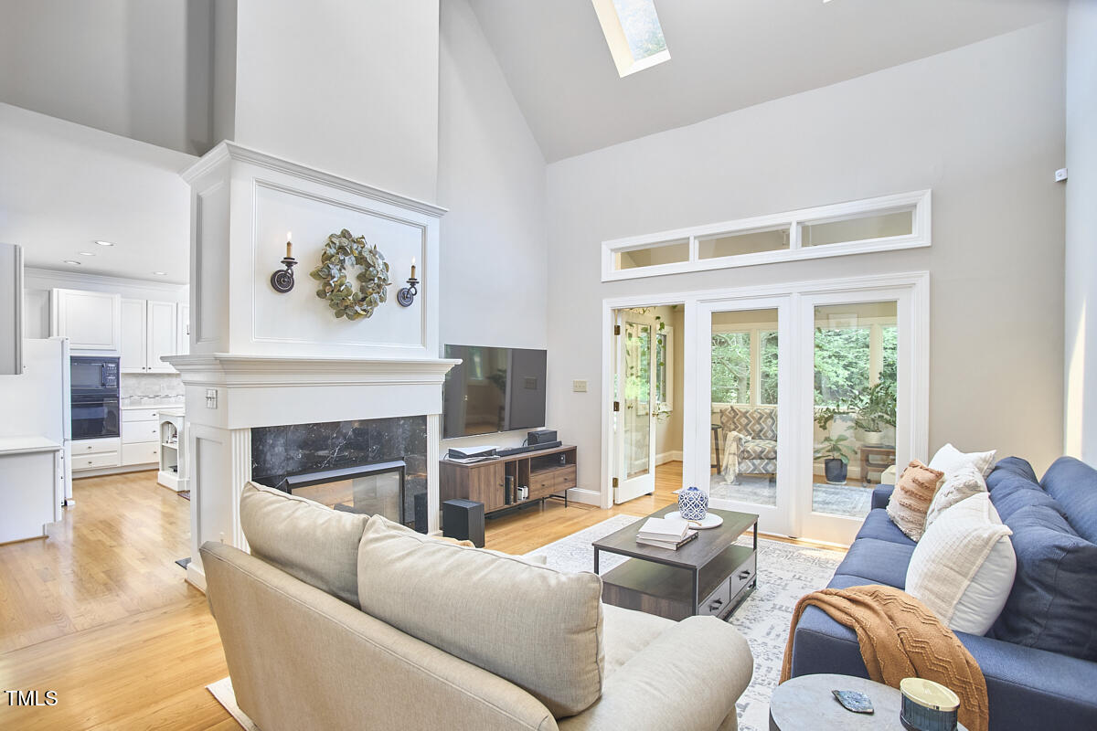 8605 Stanton Place Raleigh, NC 27615 - Photo 10 of 56 a living room with furniture large window and fireplace