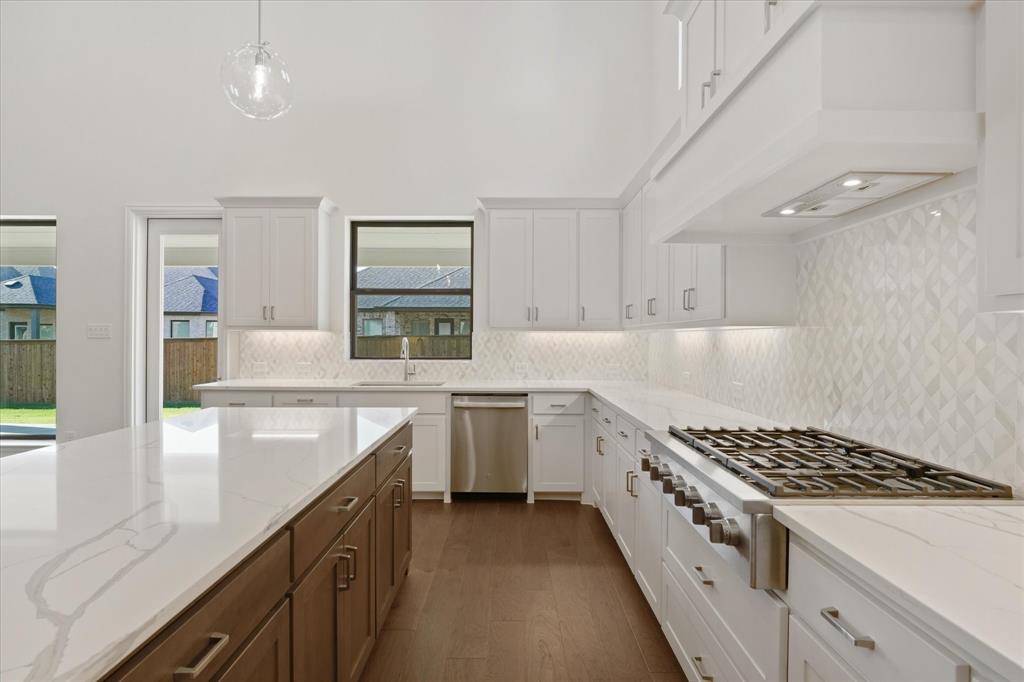 4626 Rillstone Road Midlothian, TX 76065 - Photo 10 of 40 Kitchen with decorative backsplash, stainless steel appliances, and white cabinetry