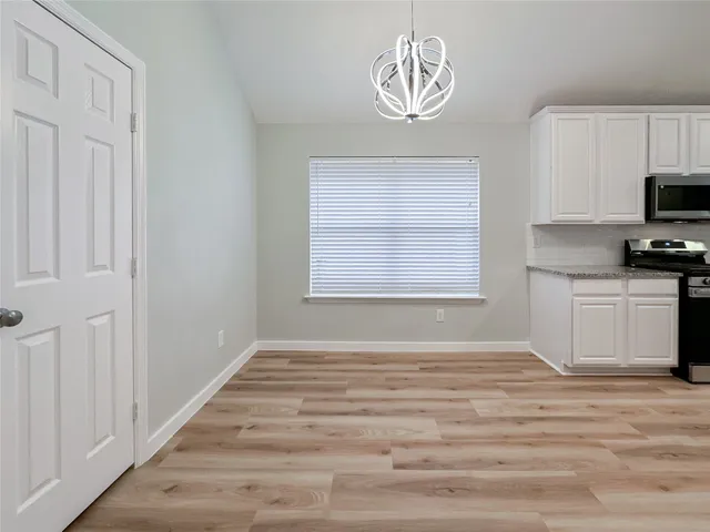 a view of a kitchen with a microwave and cabinets