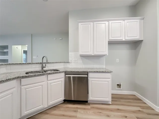 a kitchen with appliances cabinets and a sink