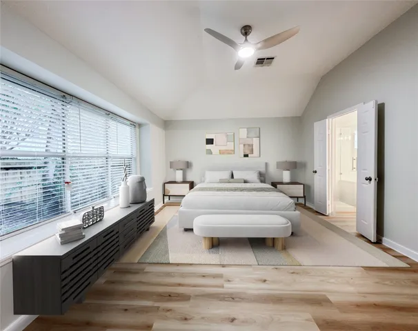 a spacious bedroom with a bed and a large window