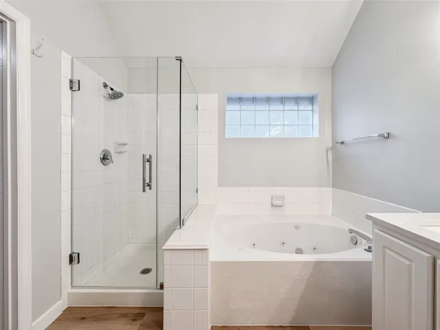 a bathroom with a bathtub and a shower