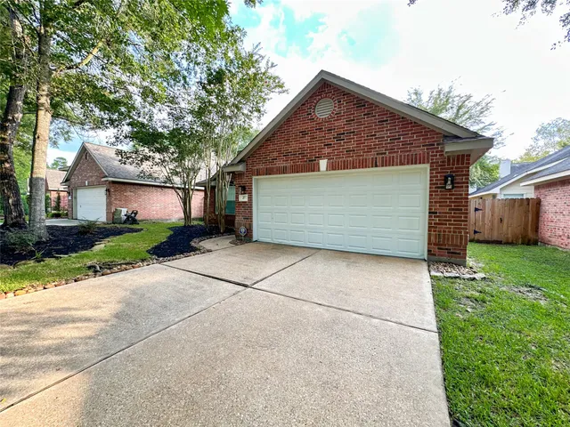 a front view of a house with a garden and garage