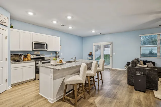 a kitchen with a stove a sink and a refrigerator