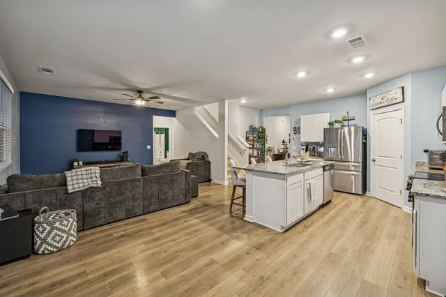 a large white kitchen with cabinets a sink and a stove