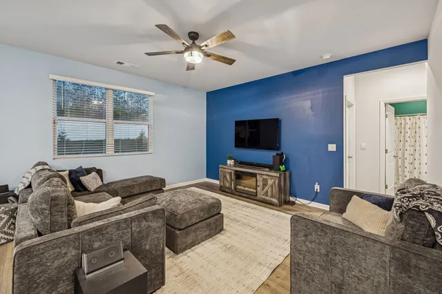 a bedroom with furniture and a flat screen tv