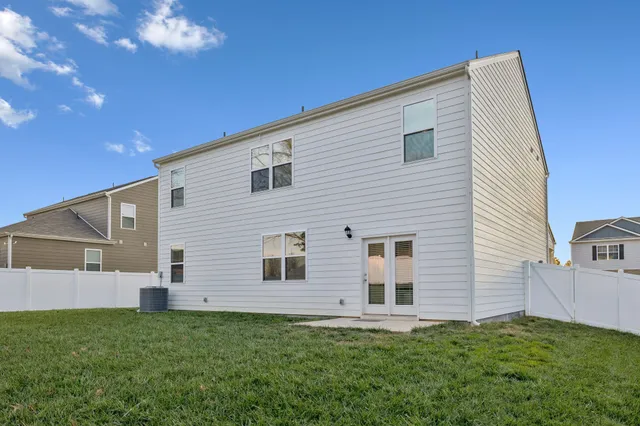 a view of backyard of house with stairs and entertaining space