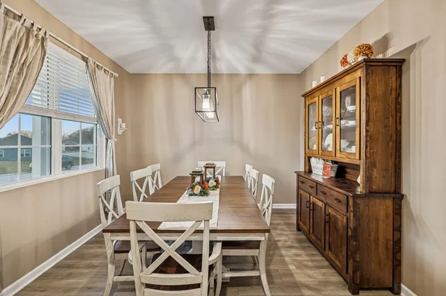 a view of a dining room with furniture window and wooden floor