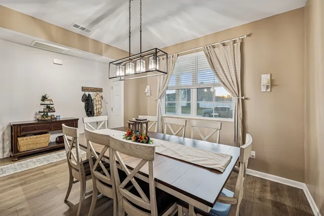 a dining room with furniture and window