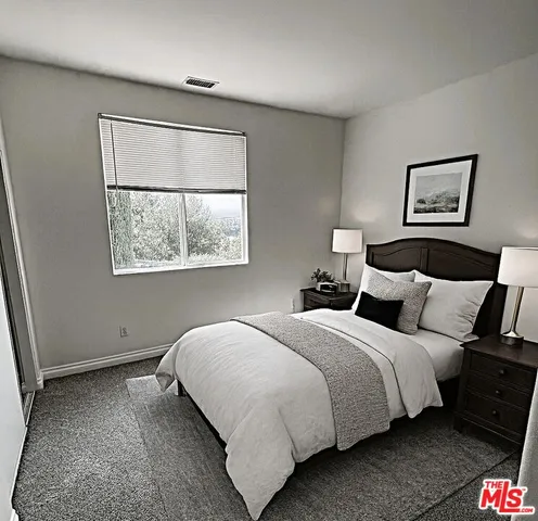a bedroom with bed and a window