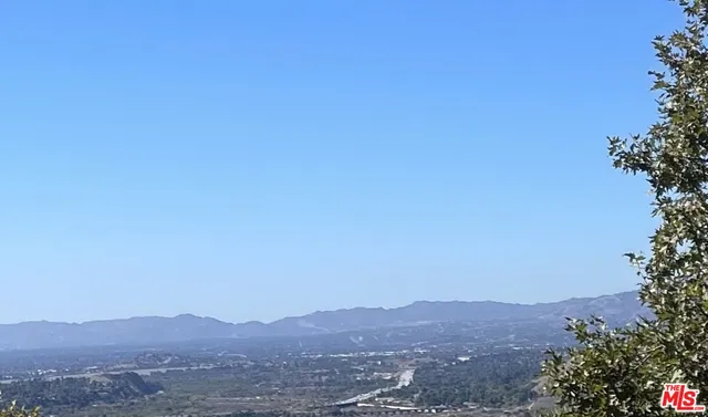 a view of a mountain range in a cloudy sky