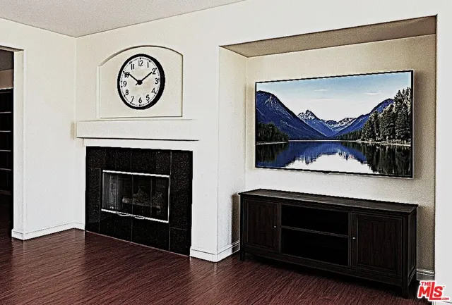 a living room with a fireplace a clock and a wall painting