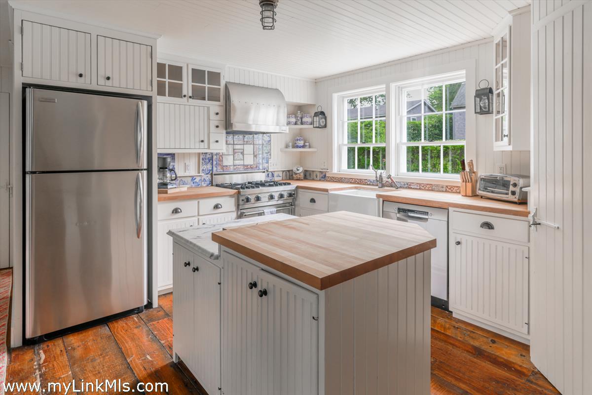 14 & 16 Coffin Street Nantucket, MA 02554 - Photo 35 of 50 a kitchen with a sink a refrigerator and window