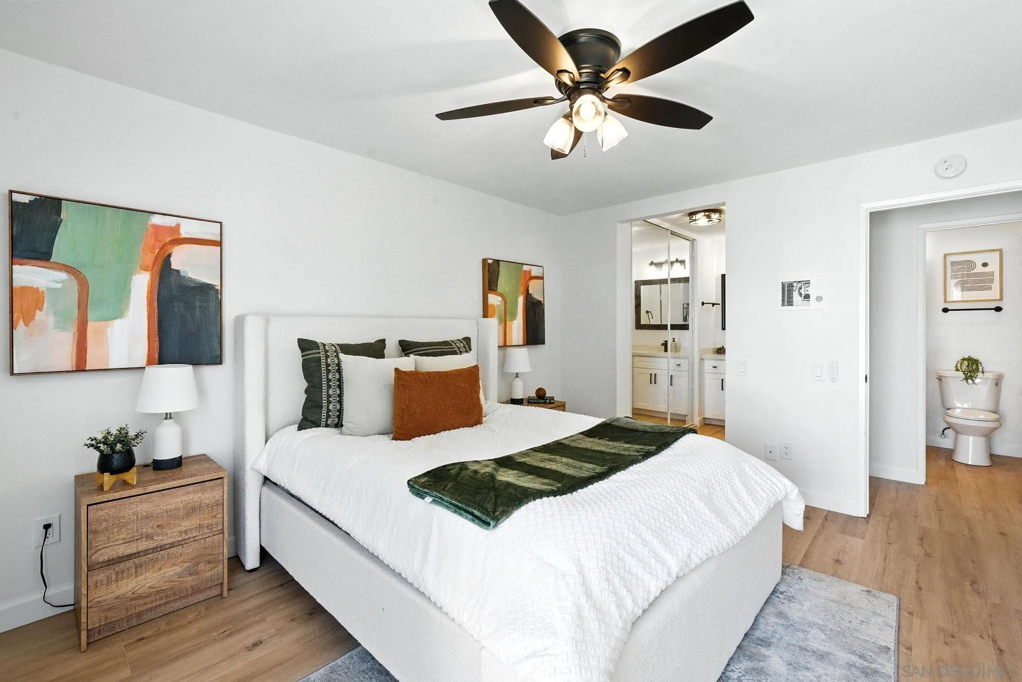 3575 Ruffin Road, Unit 204 San Diego, CA 92123 - Photo 14 of 29 a bedroom with a bed and wooden floor