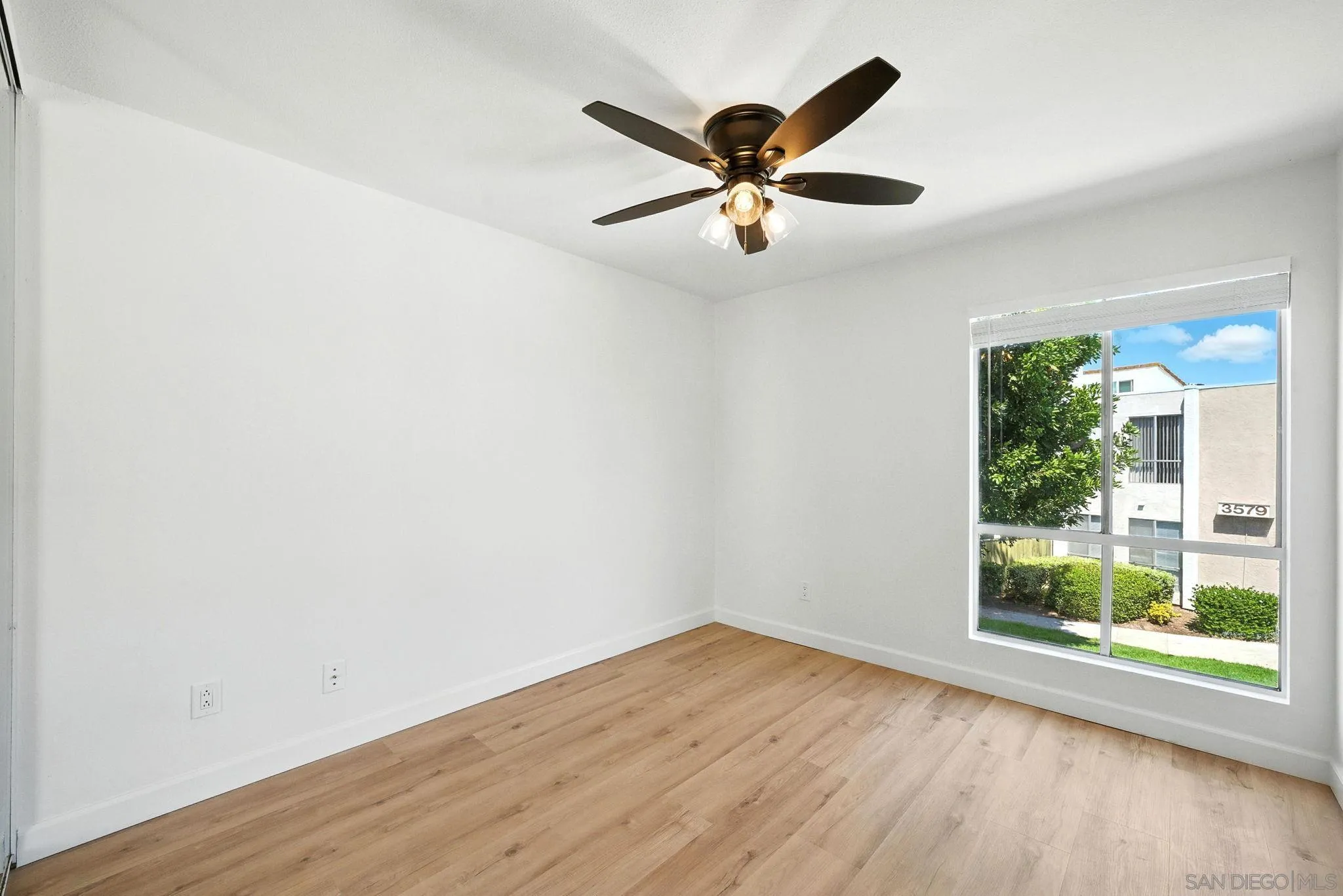 3575 Ruffin Road, Unit 204 San Diego, CA 92123 - Photo 18 of 29 an empty room with wooden floor fan and windows