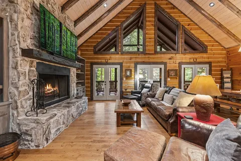 a living room with furniture and a chandelier