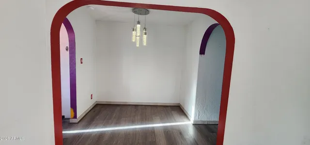 a view of a room with wooden floor and staircase