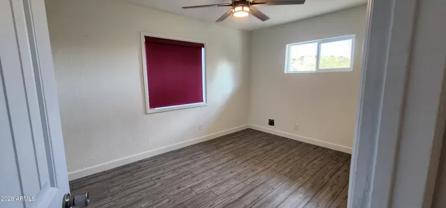 an empty room with closet and wooden floor
