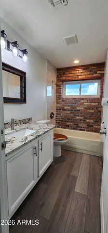 a view of a room with wooden floor and a window