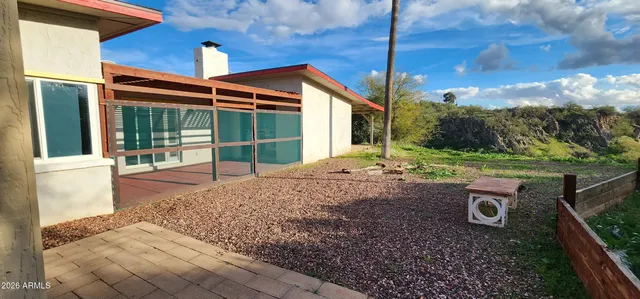 a view of a yard with mountains in the background