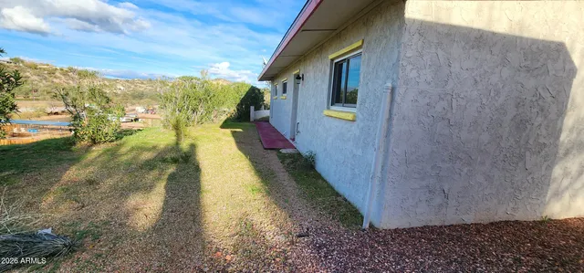 a view of a house with backyard and porch