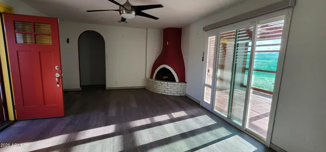 a view of a livingroom with wooden floor and furniture