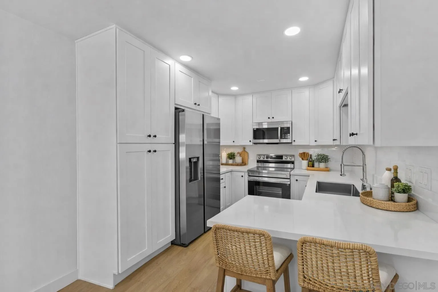 a kitchen with a refrigerator a stove and a cabinets