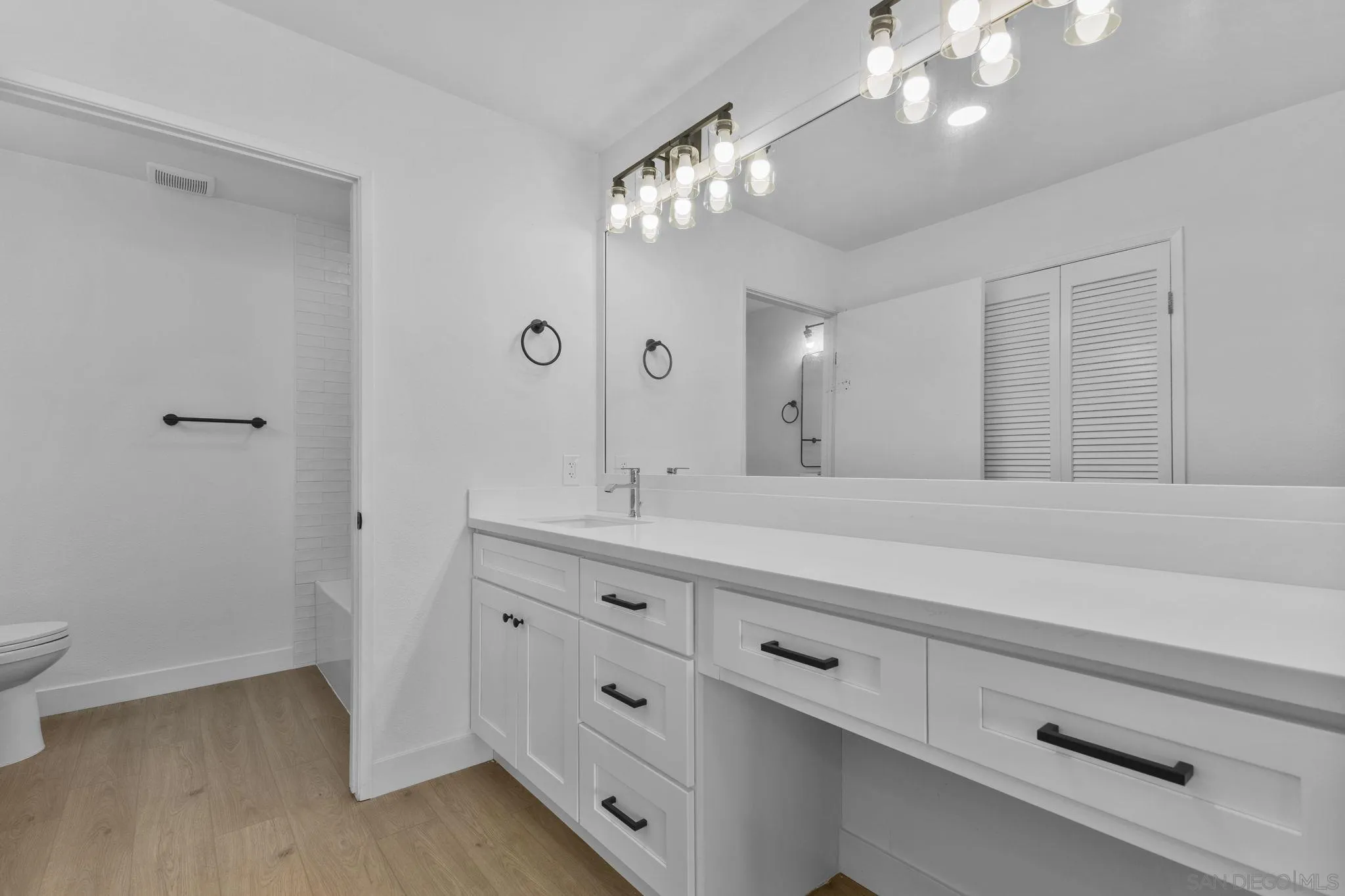 6747 Friars Road, Unit 130 San Diego, CA 92108 - Photo 18 of 32 a bathroom with a double vanity sink and a mirror