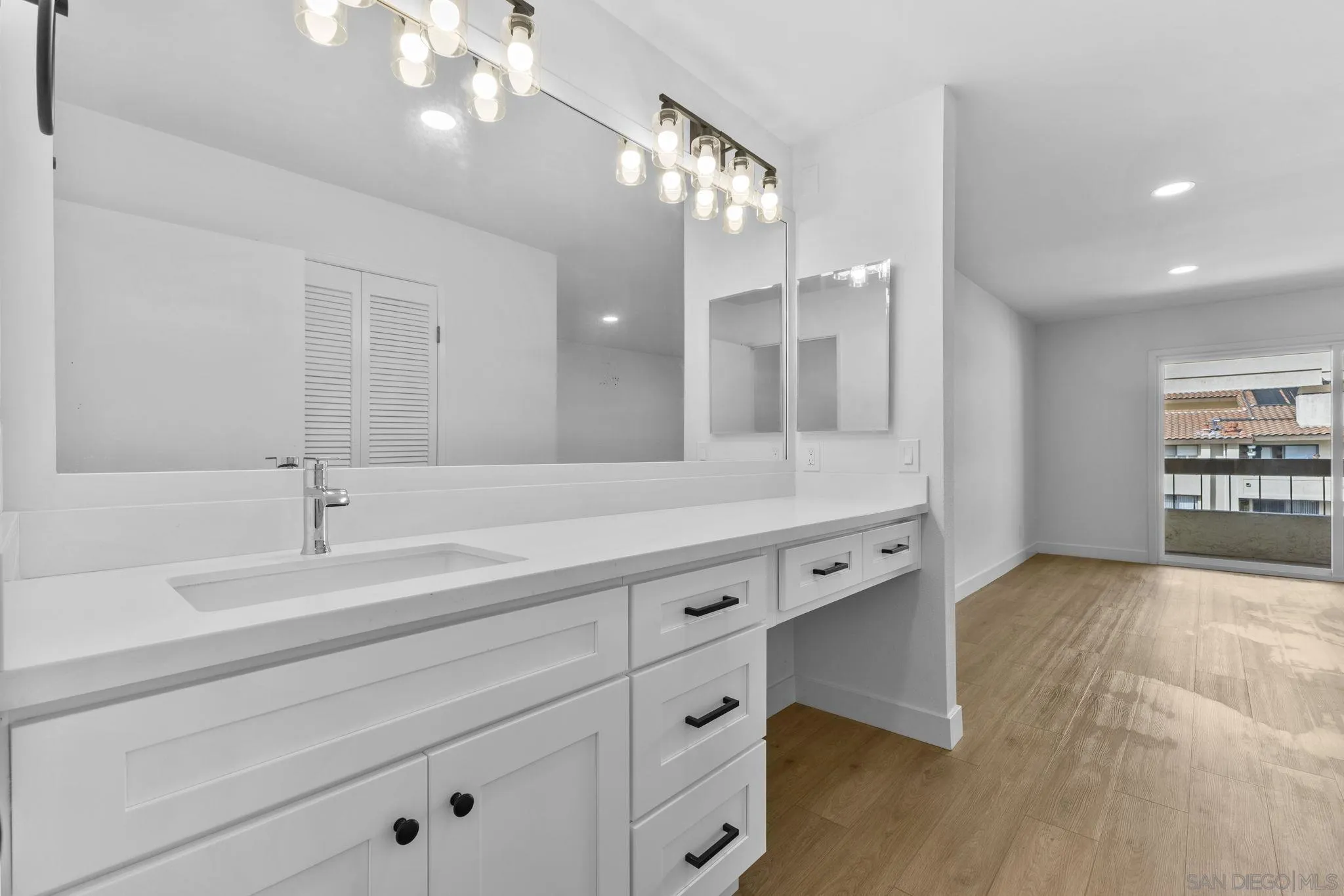 6747 Friars Road, Unit 130 San Diego, CA 92108 - Photo 19 of 32 a spacious bathroom with double vanity and a mirror