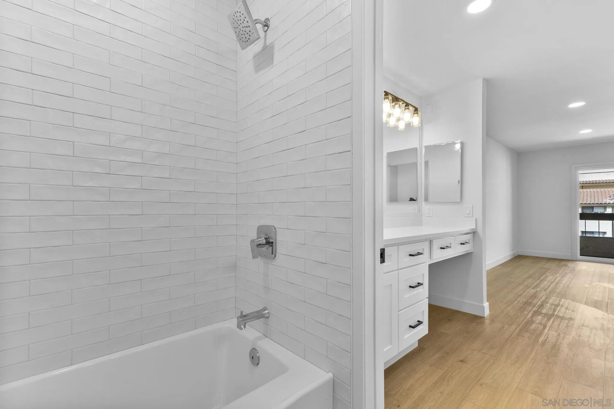 6747 Friars Road, Unit 130 San Diego, CA 92108 - Photo 20 of 32 a bathroom with a bathtub and a double vanity sink