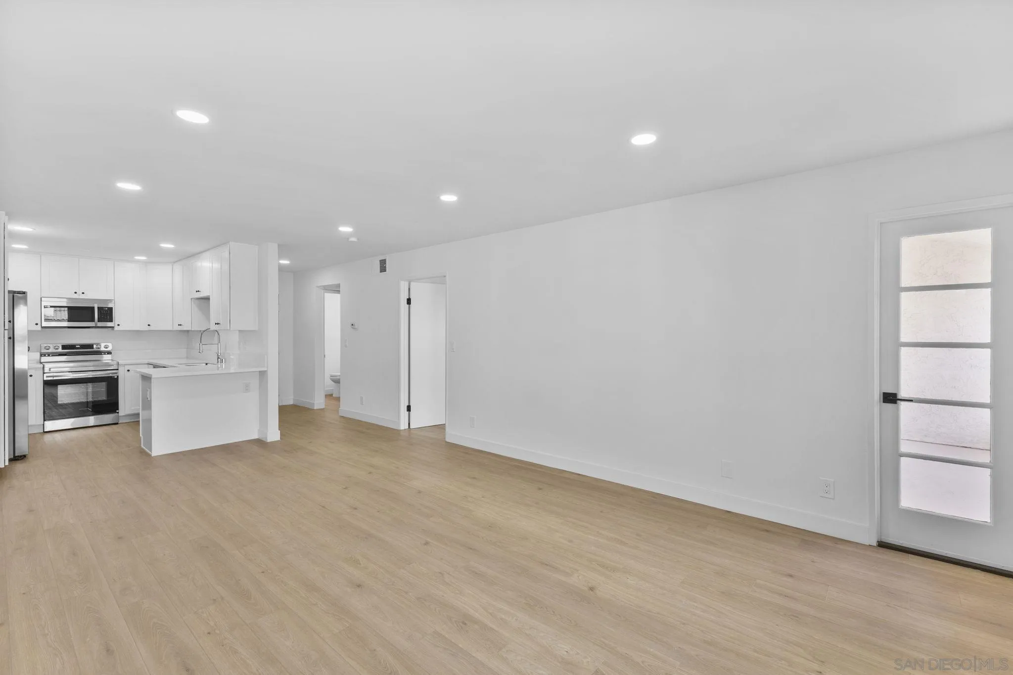 6747 Friars Road, Unit 130 San Diego, CA 92108 - Photo 7 of 32 a view of kitchen with white cabinets and stainless steel appliances