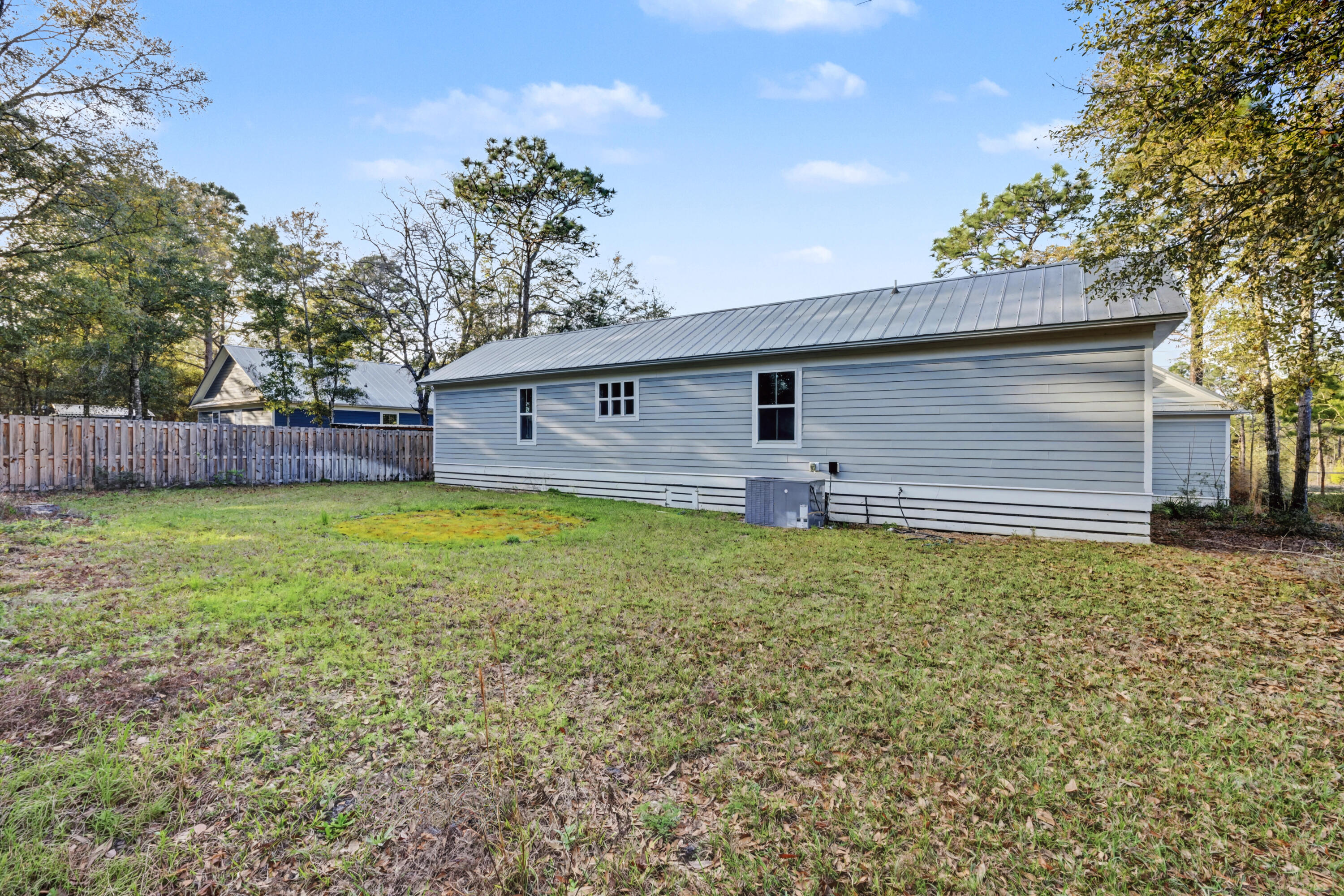 255 West Renoir Road DeFuniak Springs, FL 32433 - Photo 22 of 30 a backyard of a house with lots of green space