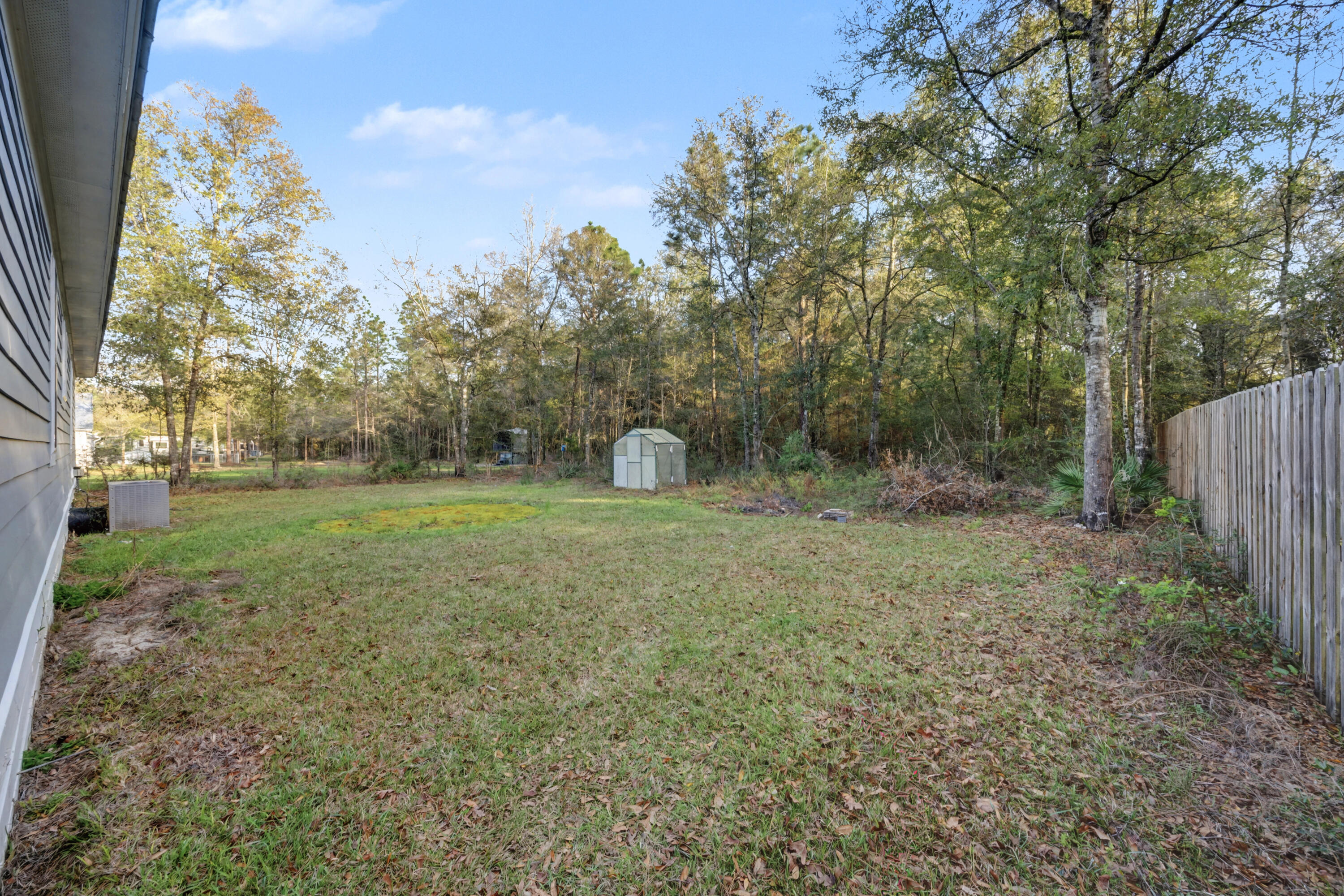 255 West Renoir Road DeFuniak Springs, FL 32433 - Photo 23 of 30 a backyard of a house with lots of green space