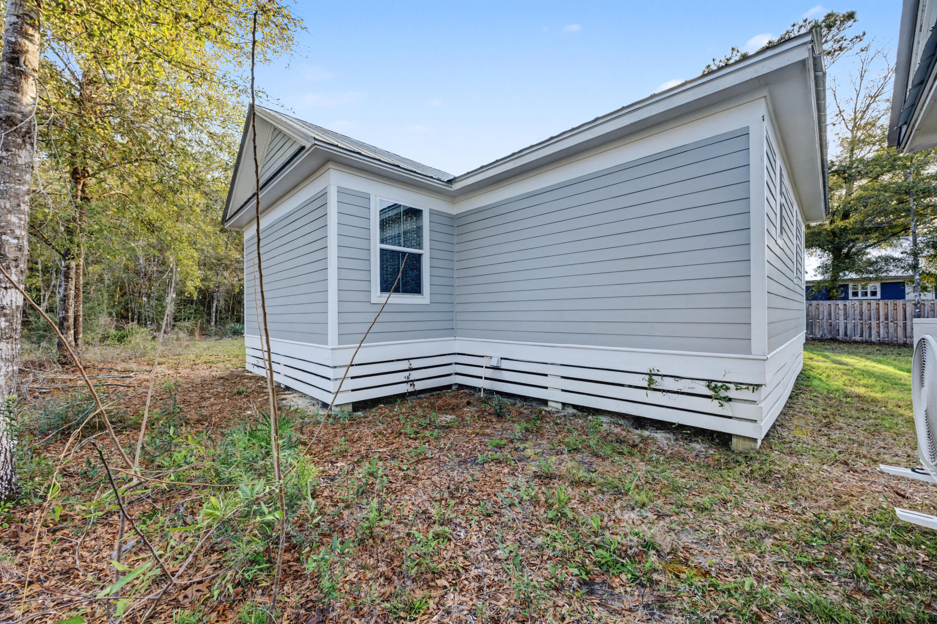 255 West Renoir Road DeFuniak Springs, FL 32433 - Photo 25 of 30 a backyard of a house with a garden and deck