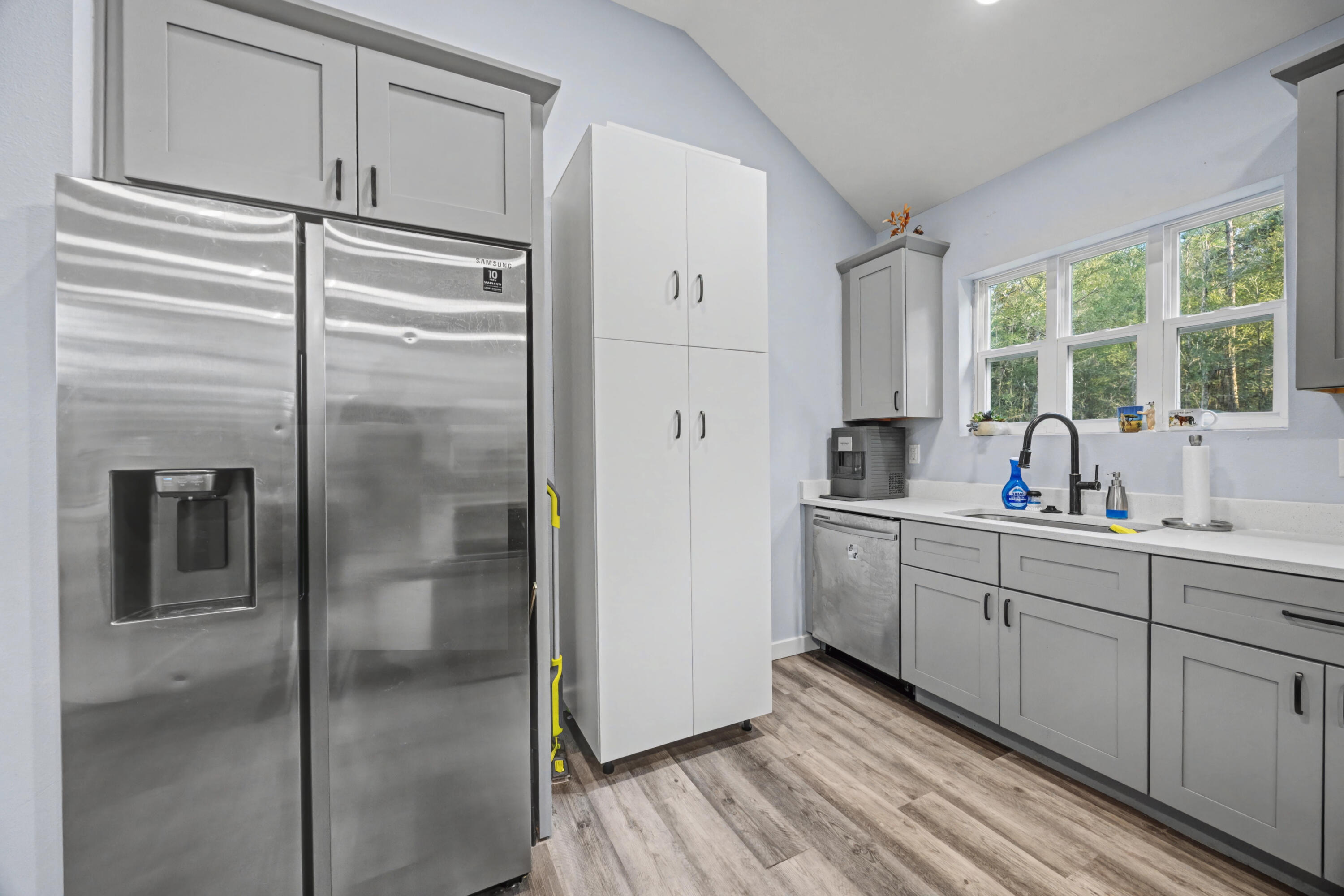 255 West Renoir Road DeFuniak Springs, FL 32433 - Photo 9 of 30 a kitchen with a refrigerator and a sink