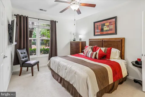 a bedroom with bed and a large window