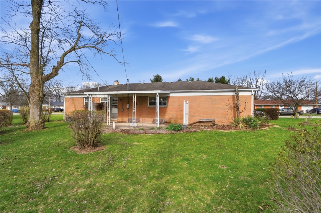 1087 Fairfield Road Troy, OH 45373 - Photo 33 of 39 This ranch-style home features a spacious yard and a covered patio, perfect for outdoor living.