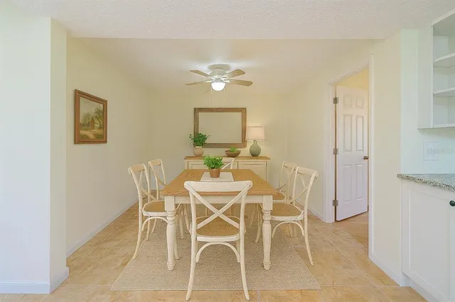 a large kitchen with granite countertop a sink counter top space a stove and stainless steel appliances
