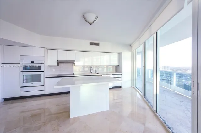 a kitchen with white cabinets and white appliances