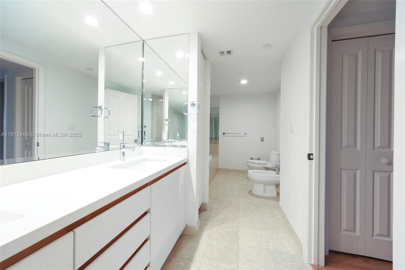 2127 Brickell Avenue, Unit 2504 Miami, FL 33129 - Photo 17 of 41 a bathroom with a sink and mirror with toilet