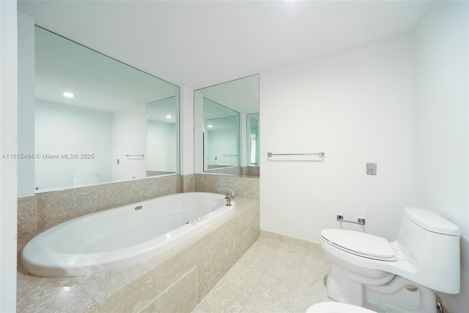 2127 Brickell Avenue, Unit 2504 Miami, FL 33129 - Photo 21 of 41 a white bath tub sitting next to a white toilet