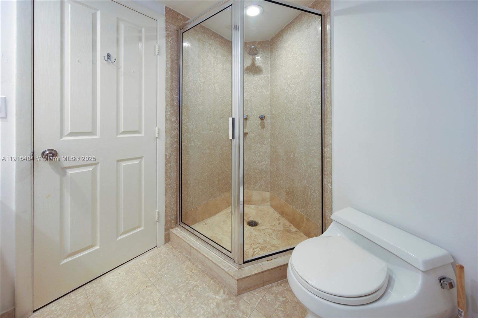 2127 Brickell Avenue, Unit 2504 Miami, FL 33129 - Photo 24 of 41 a bathroom with a shower and toilet