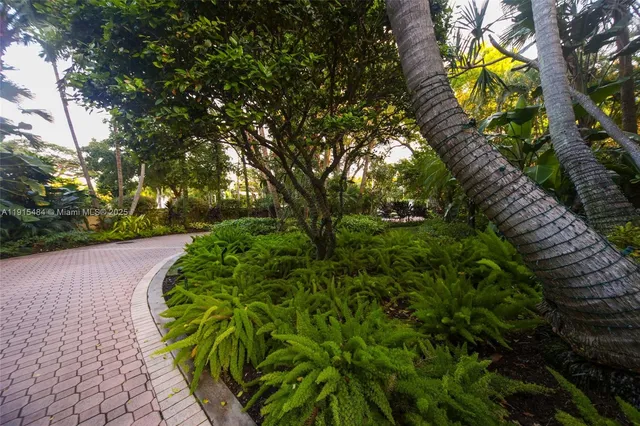 a view of a building with a garden and pathway